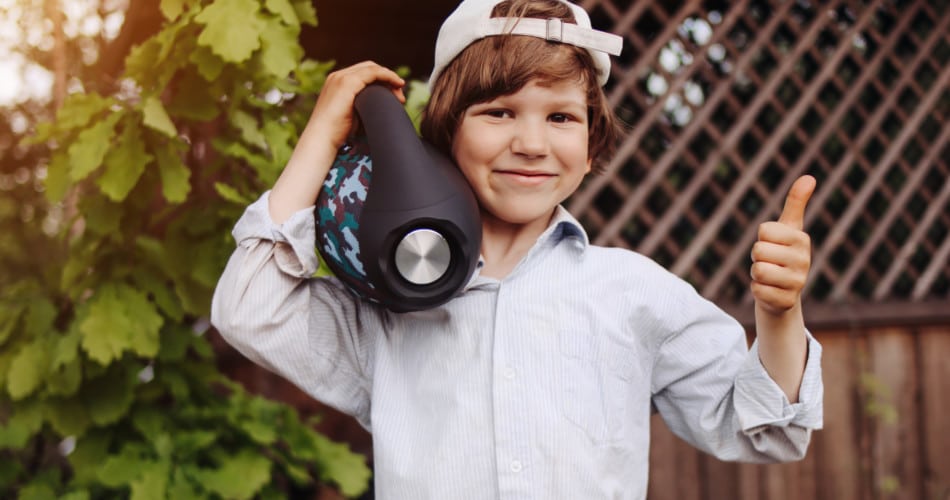 Ein Kind mit einem Radio (Audiosystem) im Arm.